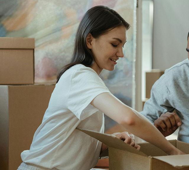 Happy customer unpacking a box, reflecting satisfaction with Champion’s portable buildings.